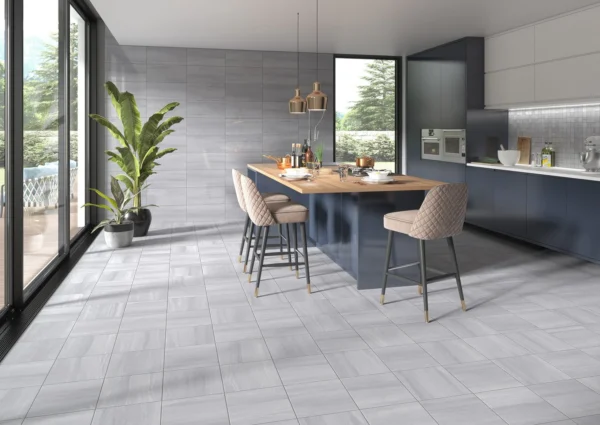 Large-format grey tile floor in a modern open commercial kitchen and bar area